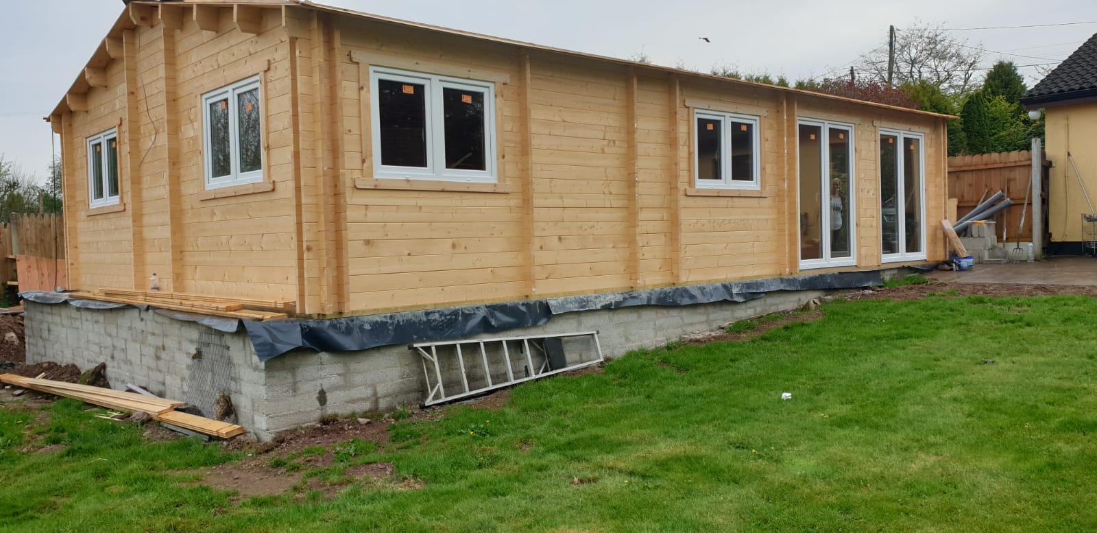 A timber frame home in the back garden of a house