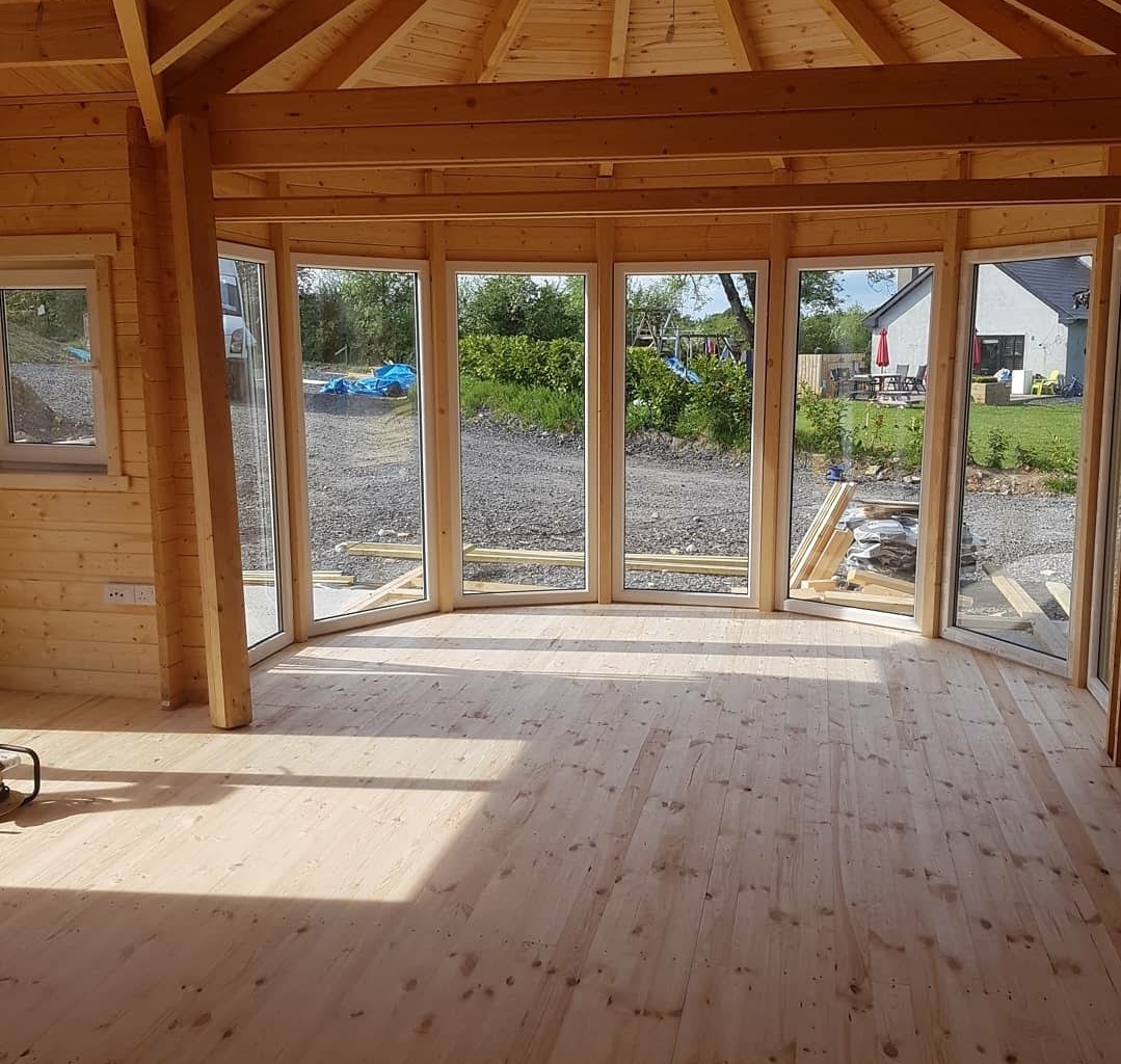 A room after being renovated with new timber flooring and windows